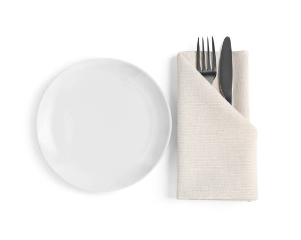 istock Empty plate, fork and knife wrapped in napkin on white background, top view 1818776120