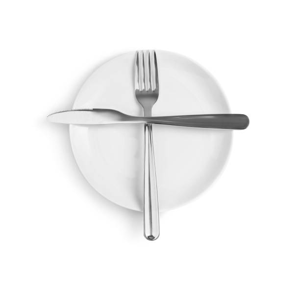 istock Ceramic plate, fork and knife on white background, top view 1818777189