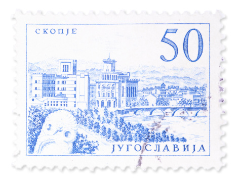Vintage Yugoslavian stamp with view from Skopje. Isolated on white with light shadow. Canon 5D Mark II.