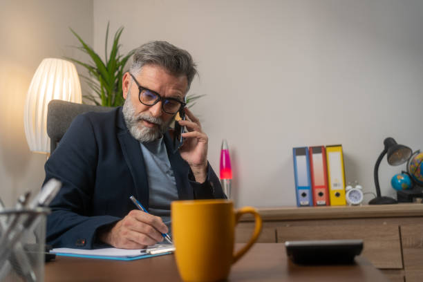 istock Businessman at the office talking on cell phone 1818786839