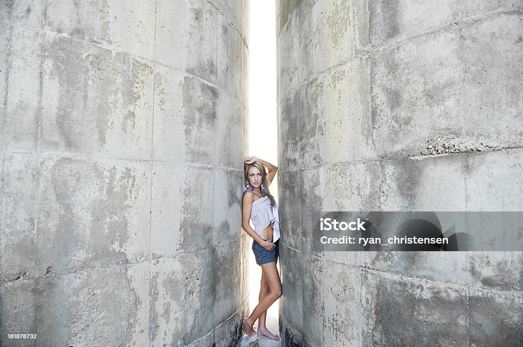 Beautiful Young Woman Standing Between Two Cement Walls Beautiful seductive young woman posing between two cement walls. Adult Stock Photo