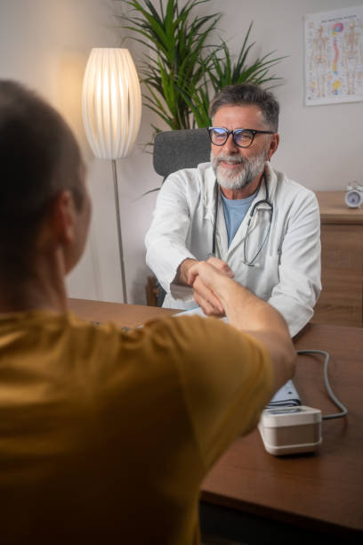 istock Smiling man handshaking with doctor in clinic 1818787385