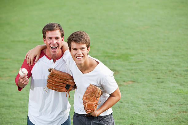 istock Father and teenage son playing baseball 181878742