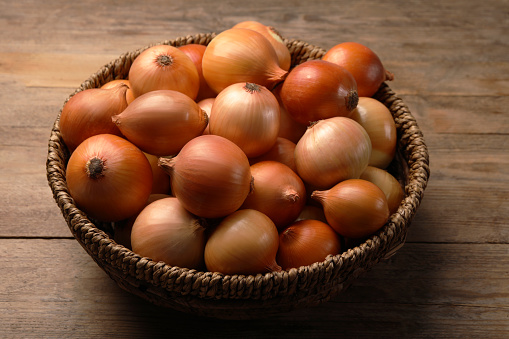 Onions on dark wooden surface