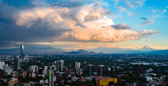 Mexico City cityscape with snowcapped volcanoes Popocatepetl and Iztaccihuatl