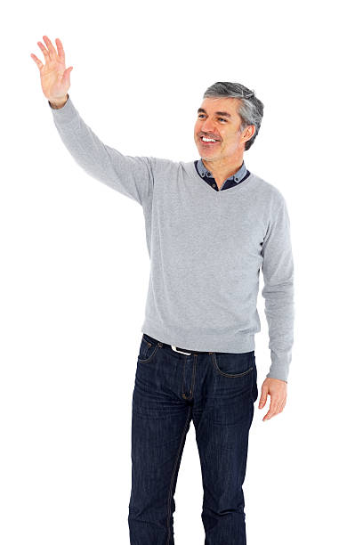 istock Happy mature man waving away against white 181878972