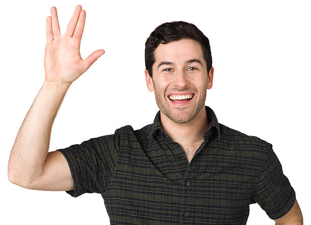 Man Gives Vulcan Salute Hand Gesture Portrait of a young caucasian man on a white background. vulcan salute stock pictures, royalty-free photos & images