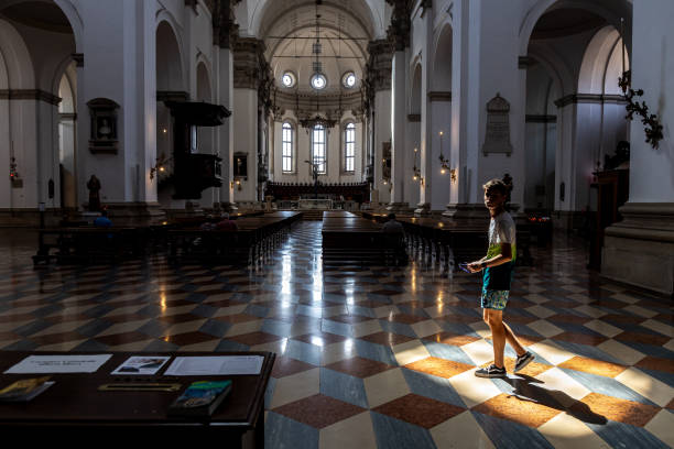 Interior view of Padua Cathedral. Silhouette of a person walking lit by the sunlight Padova, Veneto, Italy - Jun 22nd, 2023: Interior view of Padua Cathedral. Silhouette of a person walking lit by the sunlight religion sunbeam one person children only stock pictures, royalty-free photos & images