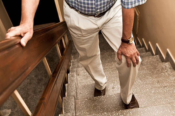 Pain Senior adult having knee pain while climbing up stairs human knee stock pictures, royalty-free photos & images