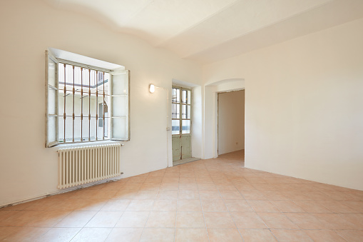 Empty room in apartment interior with white walls in old country house in Italy
