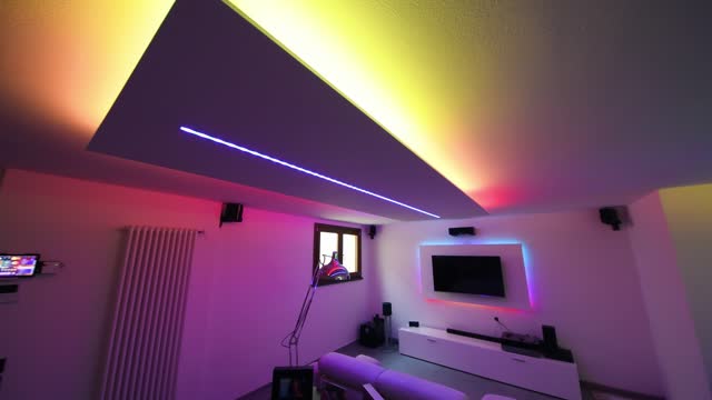 Modern Basement room illuminated by led lights of many colors
