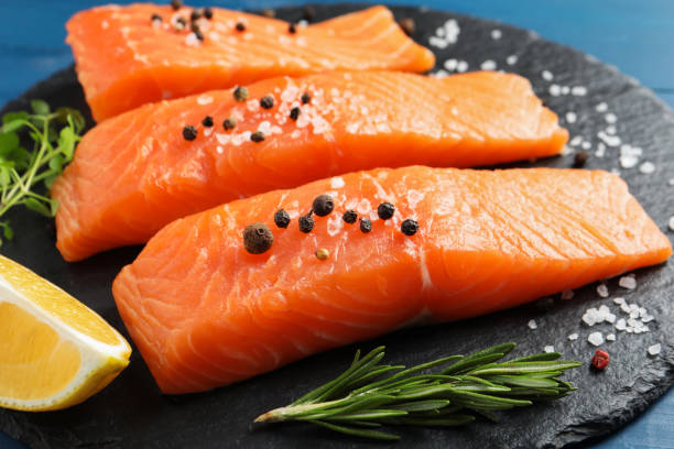 istock Fresh raw salmon and ingredients for marinade on slate board, closeup 1818805472