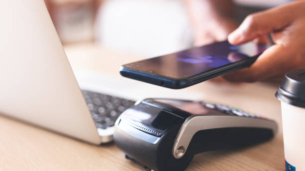 istock Hands making contactless transaction with card or mobile phone, highlighting security and data protection. 1818805520