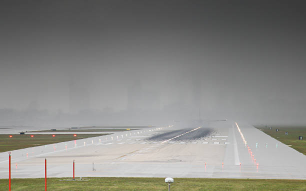 plane landing in heavy rain stock photo