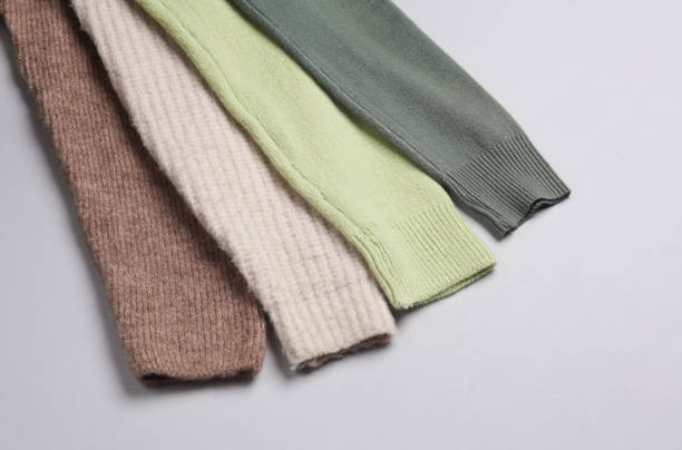 istock Sleeves of woolen sweaters on a gray background 1818807704