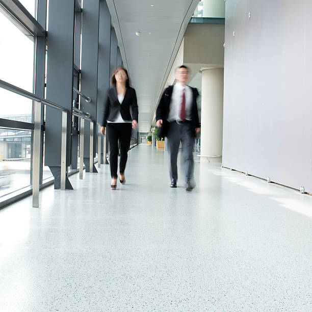 istock Business people walking in a hallway 181880936