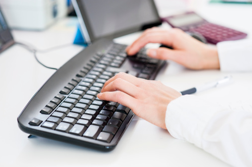 Office lady typing on computer keyboard.More business images: