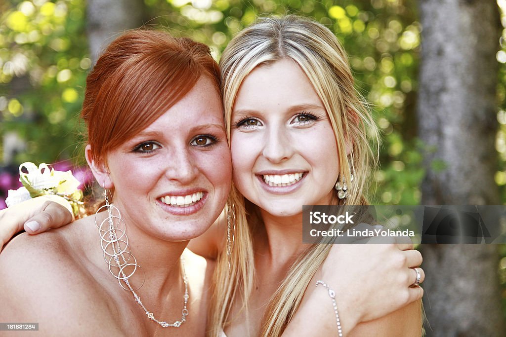 Beautiful Teen Girls A portrait of two beautiful teenage girls smiling at the camera. they are dressed up for prom. 16-17 Years Stock Photo