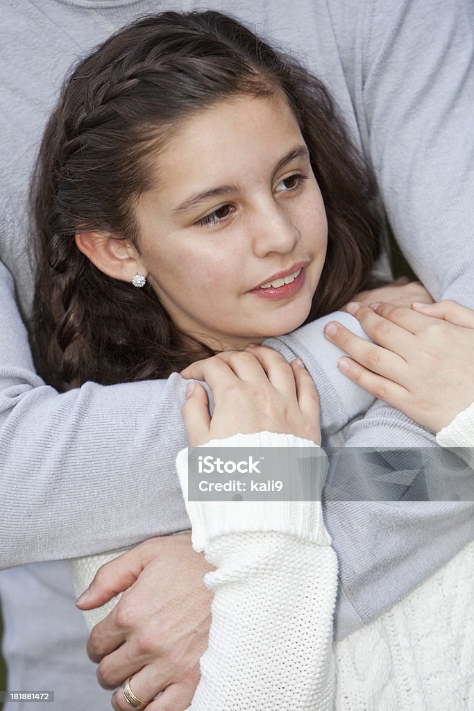 Girl hugged by dad Girl (10 years, mixed race Hispanic/Caucasian), in daddy's arms. 10-11 Years Stock Photo