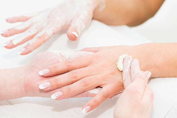 Hand cream application Hand cream application at beauty spa hand massage photos stock pictures, royalty-free photos & images
