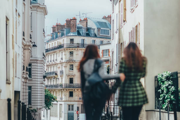Two girlfriends explore Paris stock photo