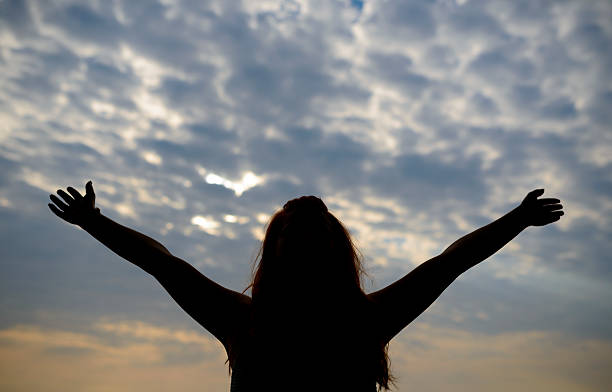 istock woman with arms raised 181882864