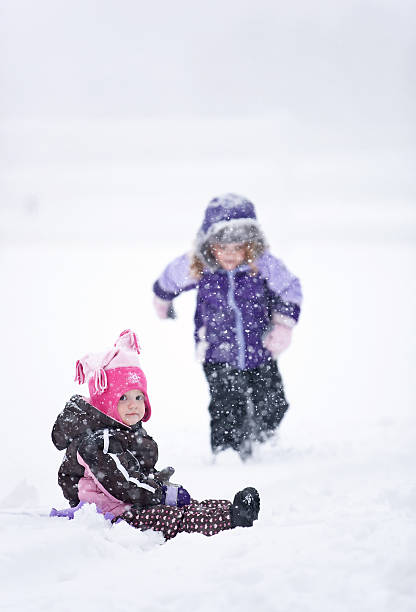 istock Girls Playing in Snow Storm 181884237