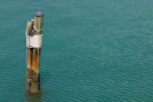 Photo of an wooden post  at a pier.