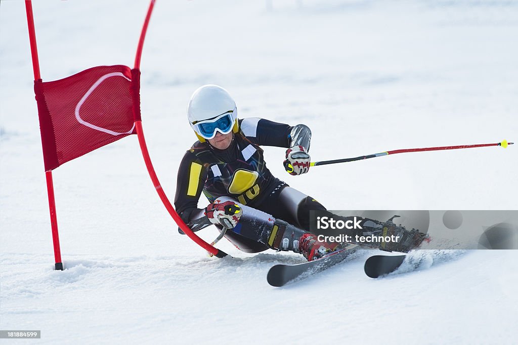 Young Professional Female Skier at Giant Slalom Race Front view of young female professional skier at giant slalom competition cup Ski Stock Photo