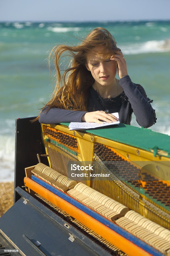 girl with long hair on the coast girl with long hair on the coast and the old piano 20-29 Years Stock Photo