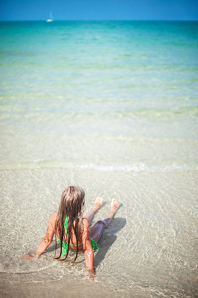 istock Little girl relaxing on the beach 181885741