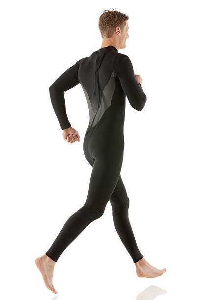 istock Young man running in wet suit 181886014