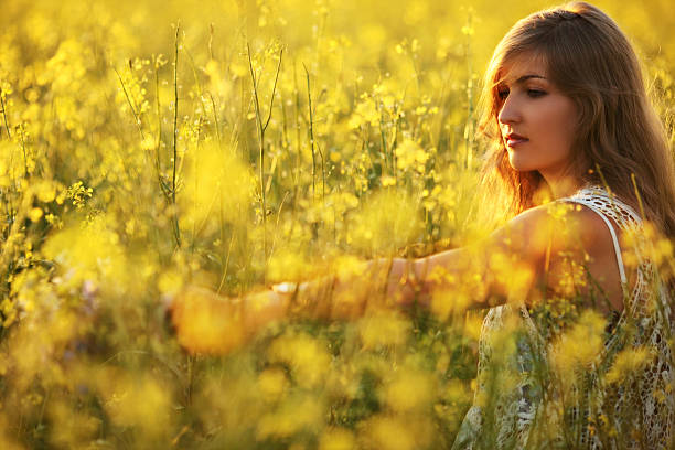 istock young woman on a flower meadow 181886036
