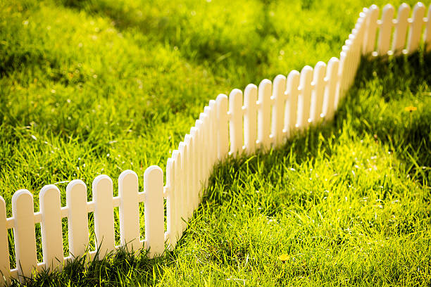 istock White fence on the grass 181886137