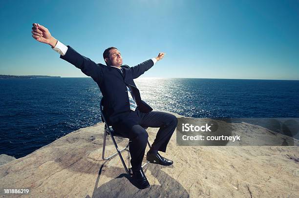 Businessman Relaxing By The Ocean Stock Photo - Download Image Now - Adult, Adults Only, Arms Outstretched