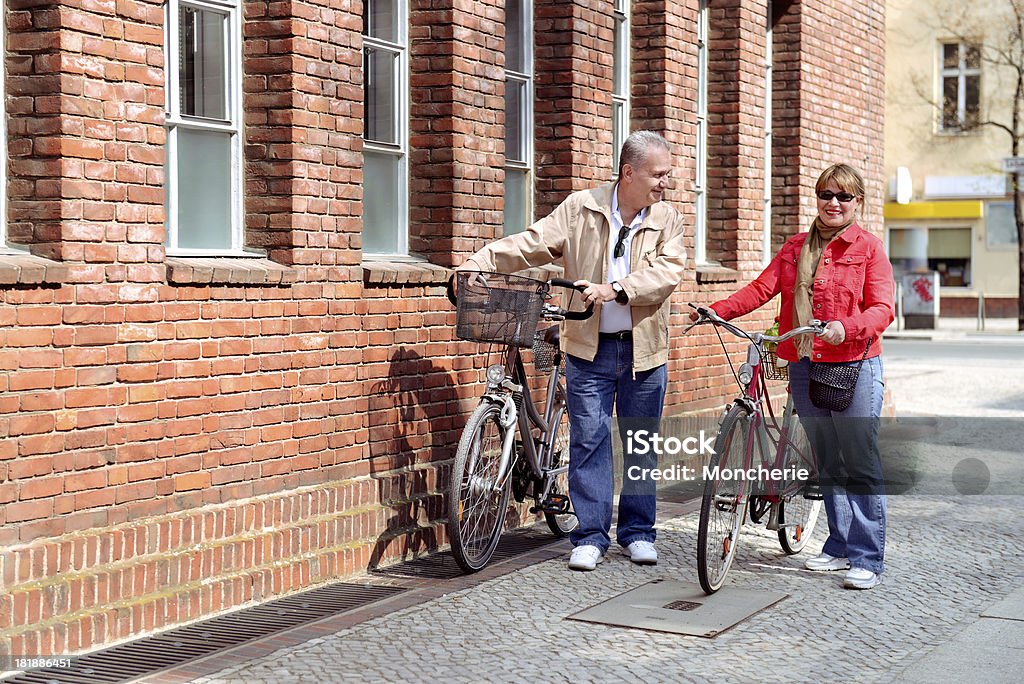 Beautiful mature couple with cycles in the city Adult Stock Photo