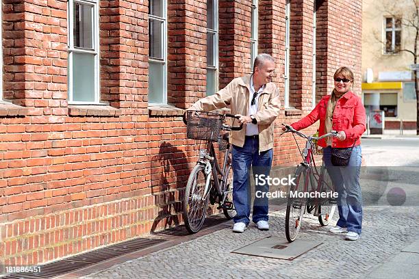Beautiful Mature Couple With Cycles In The City Stock Photo - Download Image Now - Adult, City, Cycling