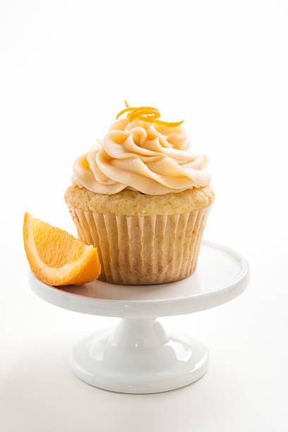 Dewlicious muffin with a piece of strawberry on top surrounded by sliced yellow lemons