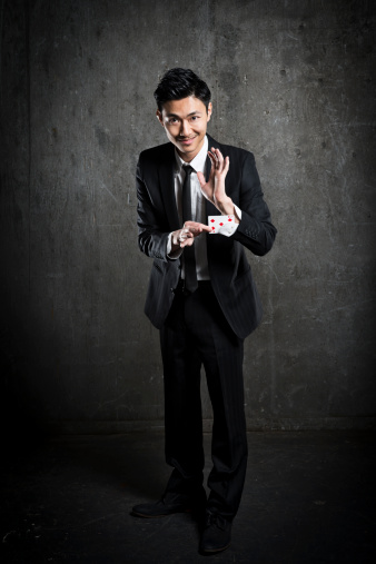 An Asian magician with a card trick