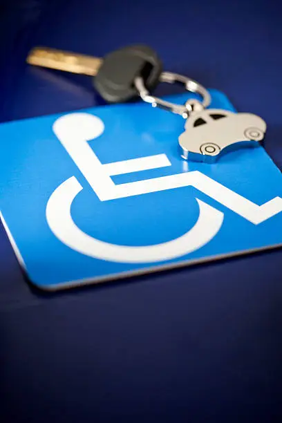 "Universal handicapped person symbol with a chrome, car key fob. Good copy space."
