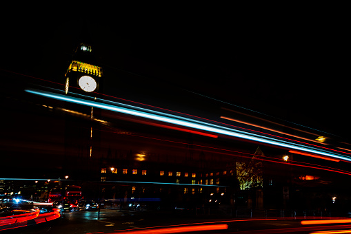 London, England - May 30, 2015:  London Eye and open top double decker bus in the city center in London