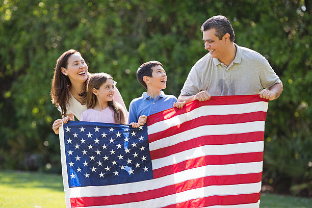 istock Children With Parents Holding American Flag 181887513