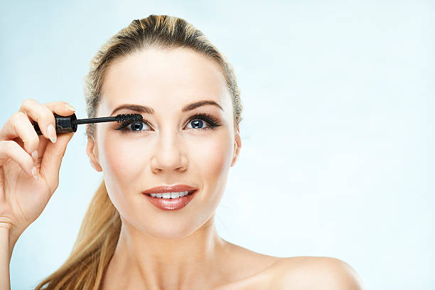 Applying mascara stock photo