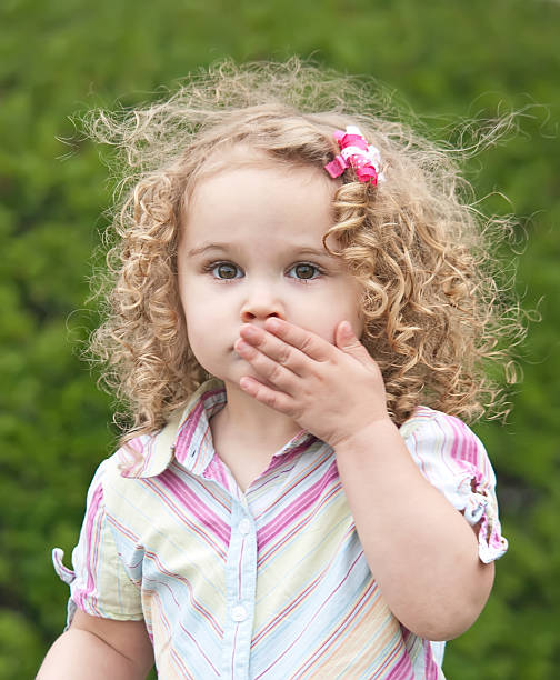 istock Girl With Hand Covering Mouth 181887673