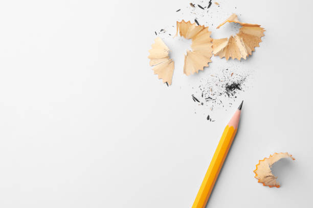 istock Graphite pencil and shavings on white background, flat lay. Space for text 1818880078