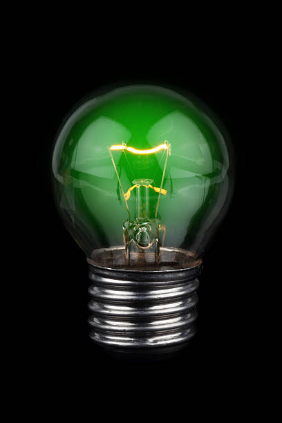istock Black isolated bulb with green filament 181888016