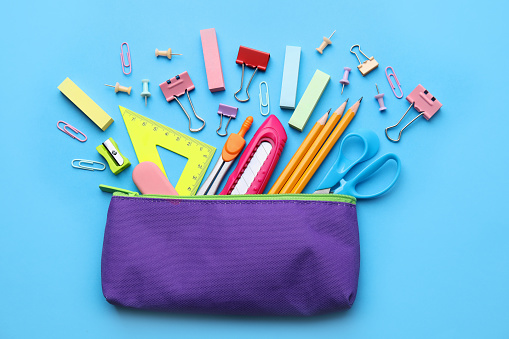 Back to school. Many different school stationery on light blue background, flat lay