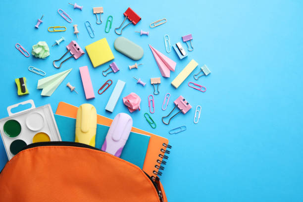 istock Back to school. Many different school stationery and paper planes on light blue background, flat lay with space for text 1818882320