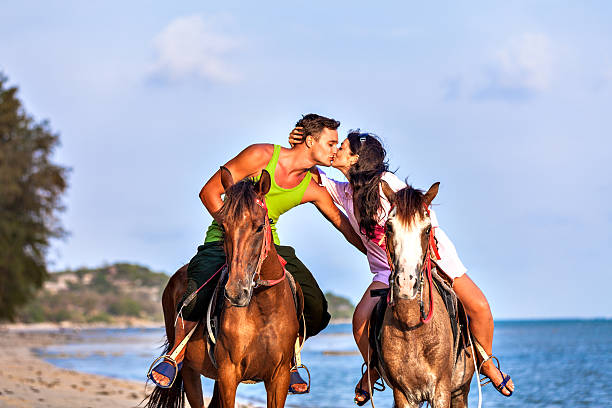 istock Couple riding horses at sunset 181888256