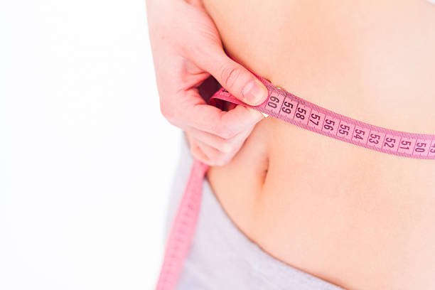 istock Bare stomach with a measuring tape 181888415